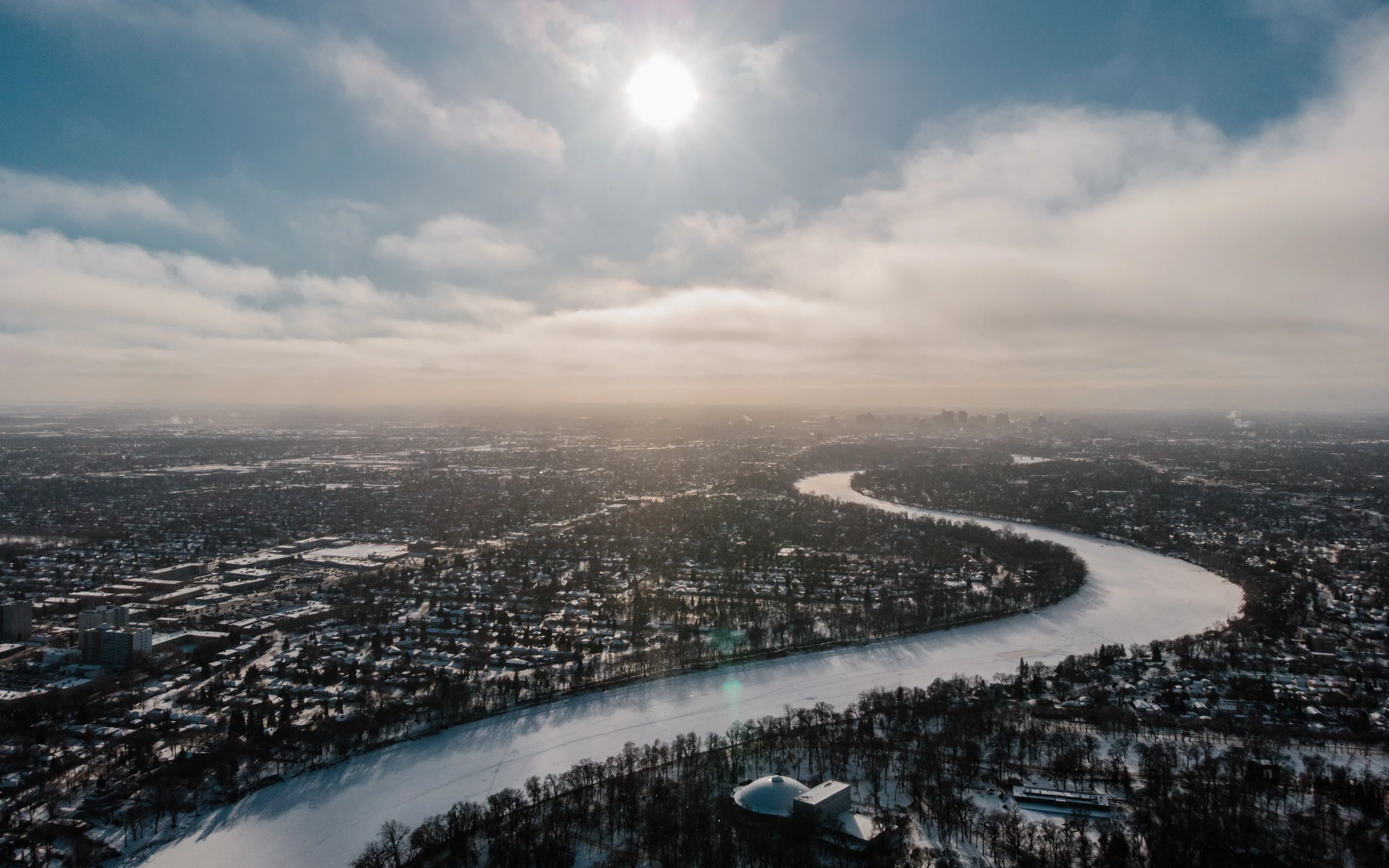 A river winding through a winter city landscape